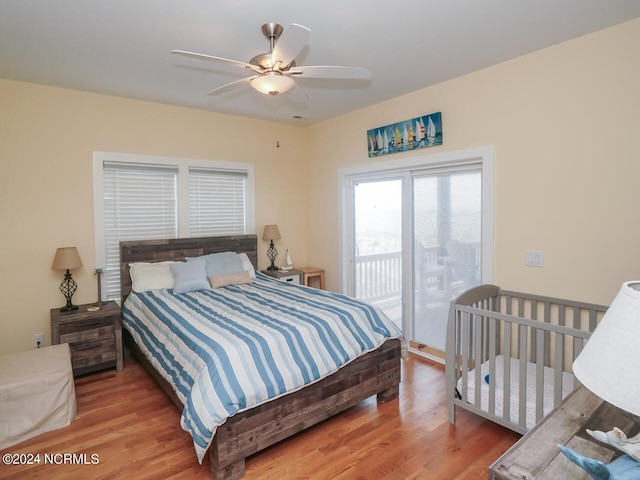 bedroom with access to exterior, a ceiling fan, and wood finished floors