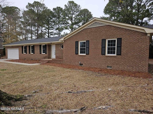 single story home featuring a garage and a front lawn