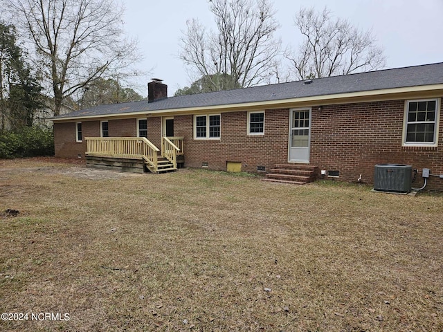 back of house with a deck, central air condition unit, and a lawn