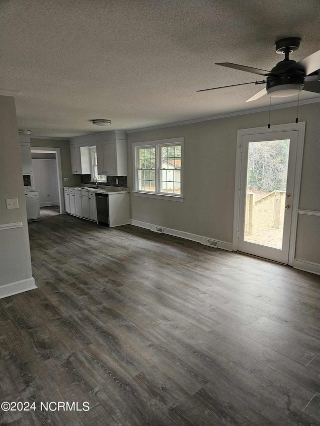 unfurnished living room featuring sink, dark hardwood / wood-style floors, a textured ceiling, and ceiling fan