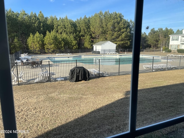 community pool with fence and a patio area