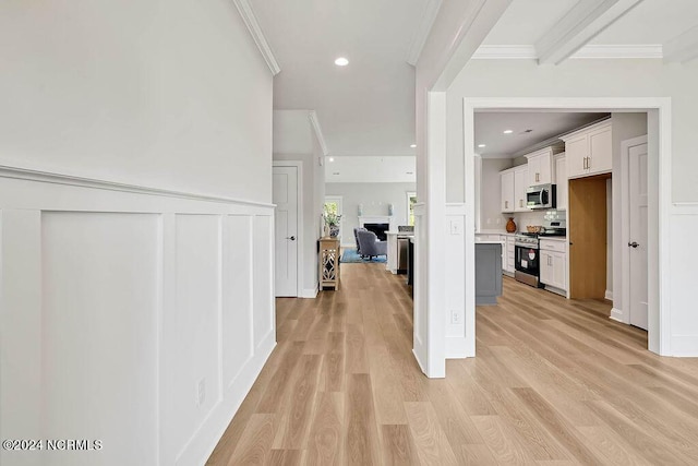 hallway featuring ornamental molding and light hardwood / wood-style flooring