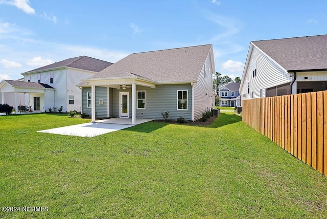 back of house featuring a patio area and a yard