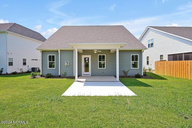 back of house featuring ceiling fan, a patio area, central AC, and a lawn