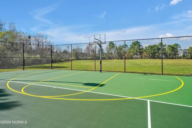 view of basketball court featuring a yard