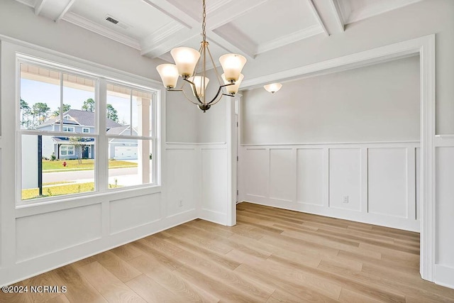 unfurnished dining area featuring a notable chandelier, beamed ceiling, crown molding, coffered ceiling, and light hardwood / wood-style flooring