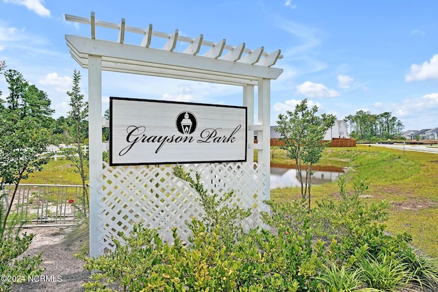 community sign featuring a water view