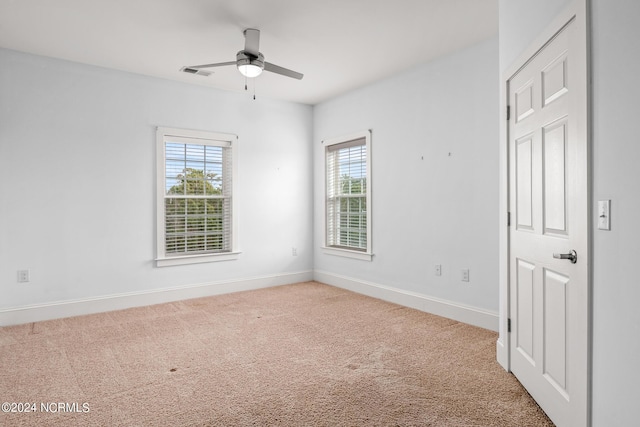 spare room featuring ceiling fan and carpet flooring