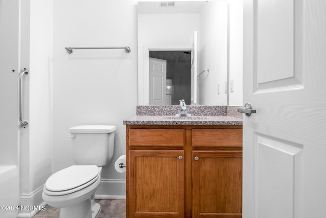 bathroom with toilet, tile patterned floors, and vanity