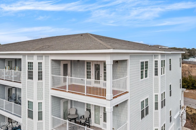 rear view of property with a balcony