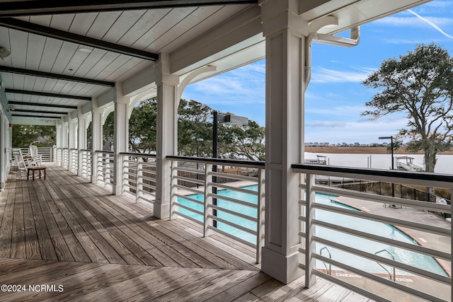 wooden deck featuring a fenced in pool