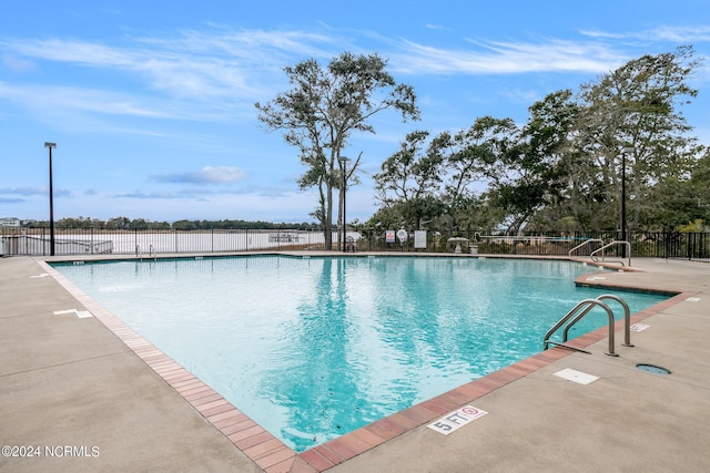 view of swimming pool with a patio area