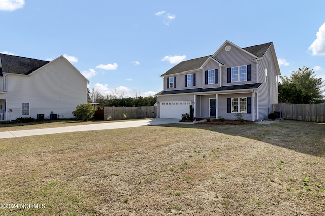 front of property with a garage, a front yard, and central air condition unit