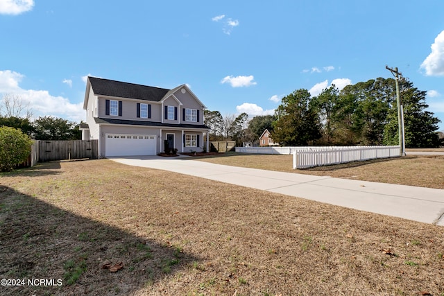 view of front property with a garage and a front lawn