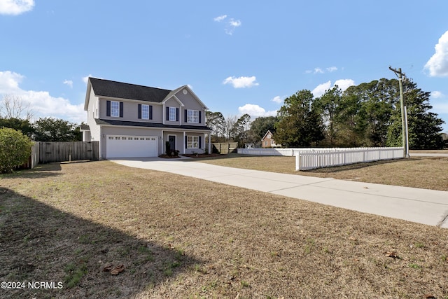 view of front of property with a garage and a front lawn