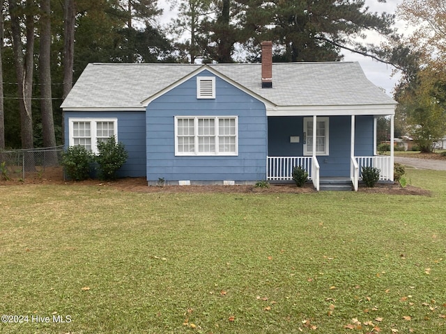 1306 N Respess St, Washington, NC 27889 - view of front of house featuring covered porch, a chimney, and roof with shingles