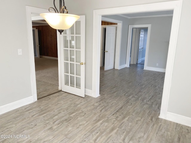 spare room with baseboards and wood finished floors