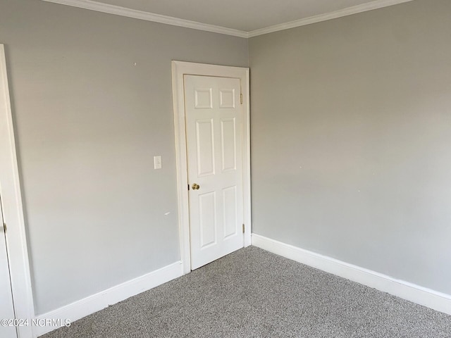 carpeted spare room with baseboards and ornamental molding