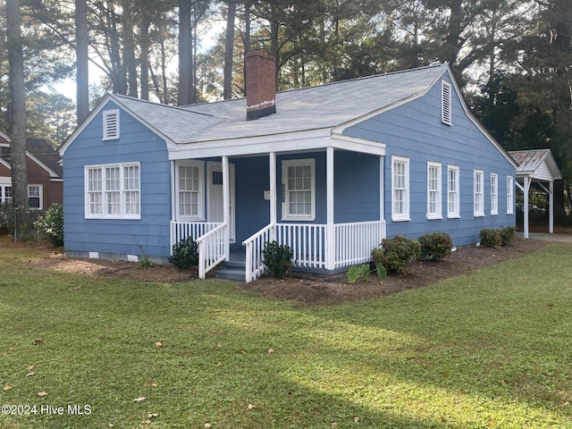 1306 N Respess St, Washington, NC 27889 - view of front of property with a chimney, a porch, crawl space, a front lawn, and roof with shingles