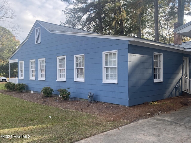 1306 N Respess St, Washington, NC 27889 - view of property exterior with a yard and a chimney
