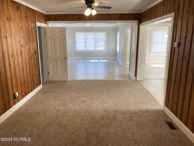 corridor featuring visible vents, carpet floors, and wood walls