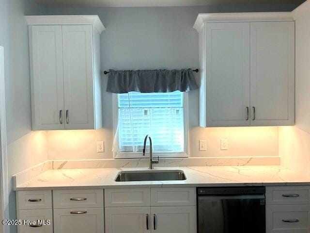 kitchen featuring light stone counters, dishwasher, white cabinets, and sink