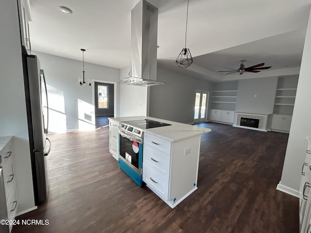 kitchen featuring appliances with stainless steel finishes, light stone counters, extractor fan, built in features, and white cabinetry