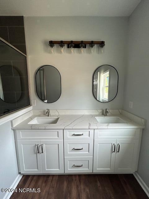 bathroom featuring vanity and wood-type flooring