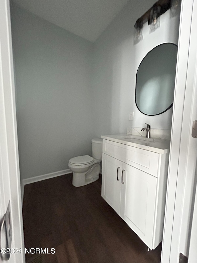 bathroom featuring hardwood / wood-style floors, vanity, and toilet