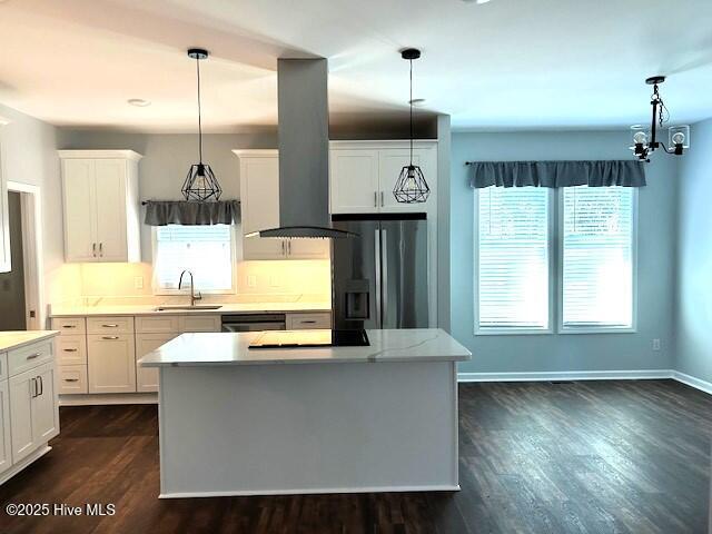 kitchen featuring white cabinets, decorative light fixtures, and stainless steel refrigerator with ice dispenser