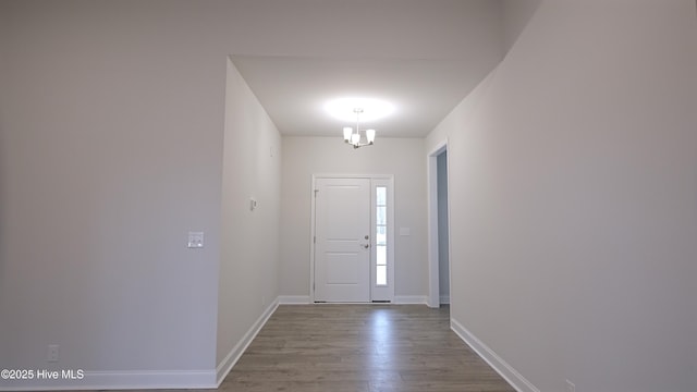 foyer featuring a chandelier and light wood-type flooring