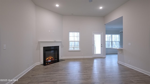 unfurnished living room with wood-type flooring