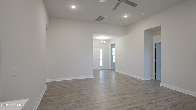 empty room with hardwood / wood-style floors and ceiling fan