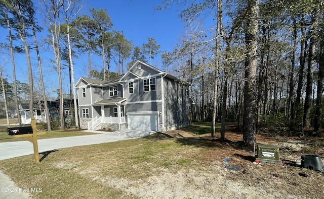 view of front facade featuring concrete driveway, an attached garage, and a front yard