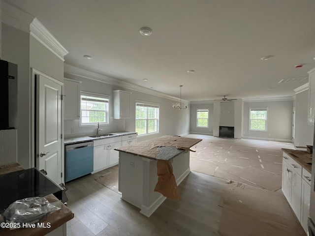 1224 Mandevilla Dr SE, Bolivia, NC 28422 - kitchen featuring dishwashing machine, a sink, ornamental molding, a center island, and white cabinetry