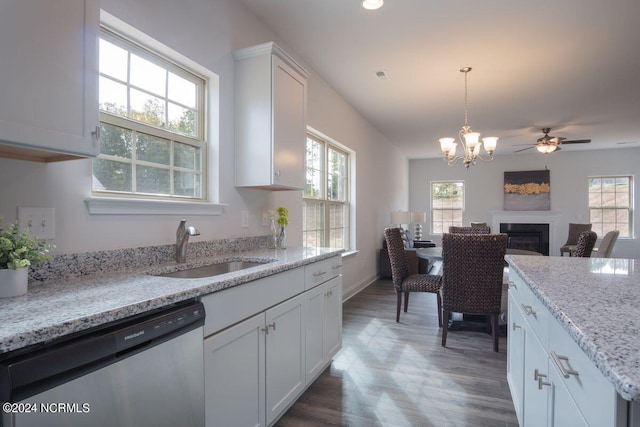 1224 Mandevilla Dr SE, Bolivia, NC 28422 - kitchen featuring dishwasher, a sink, a fireplace, dark wood-type flooring, and white cabinets