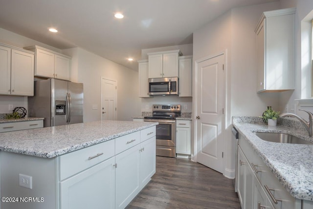 1224 Mandevilla Dr SE, Bolivia, NC 28422 - kitchen with appliances with stainless steel finishes, a sink, recessed lighting, dark wood-type flooring, and white cabinets