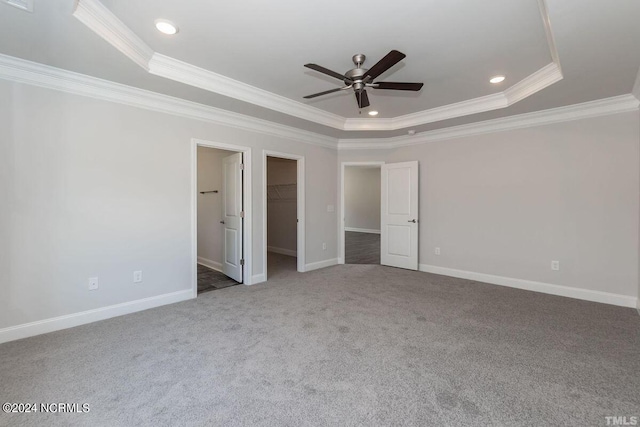 1224 Mandevilla Dr SE, Bolivia, NC 28422 - unfurnished bedroom with a tray ceiling, crown molding, carpet floors, a spacious closet, and baseboards