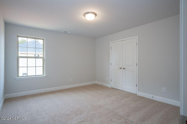 1224 Mandevilla Dr SE, Bolivia, NC 28422 - unfurnished bedroom with carpet, baseboards, and a closet