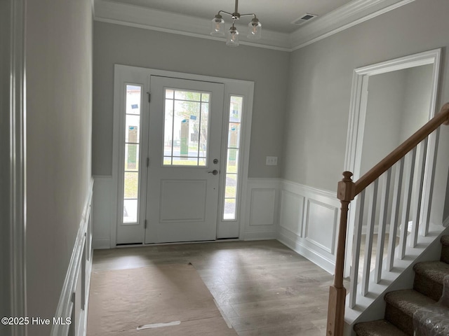 1224 Mandevilla Dr SE, Bolivia, NC 28422 - foyer entrance with ornamental molding, a decorative wall, stairway, wainscoting, and wood finished floors