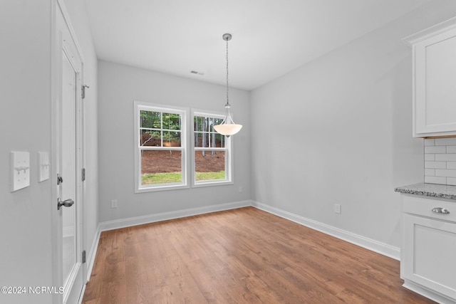 unfurnished dining area with light hardwood / wood-style floors