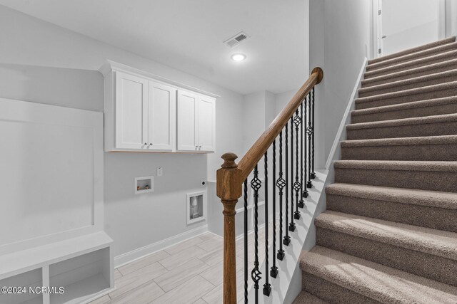 staircase featuring light tile patterned floors