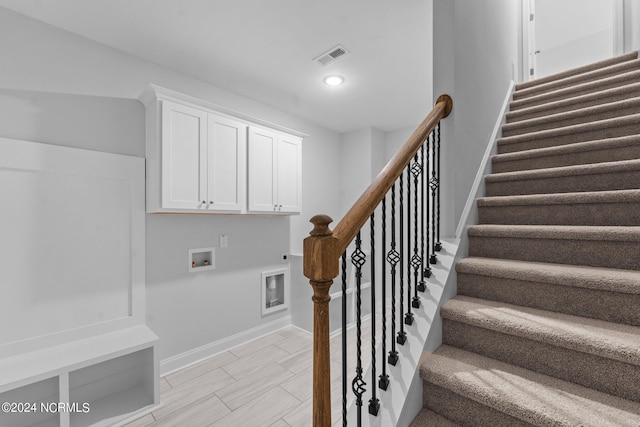 staircase with baseboards, visible vents, and recessed lighting