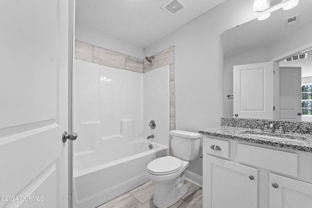 full bathroom with shower / tub combination, vanity, tile patterned flooring, and toilet