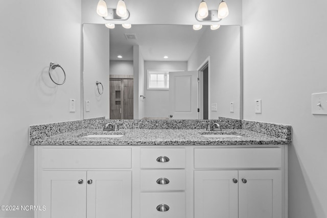 full bath with visible vents, a sink, and double vanity