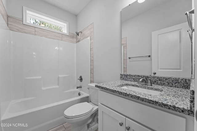 full bathroom featuring tub / shower combination, vanity, and toilet