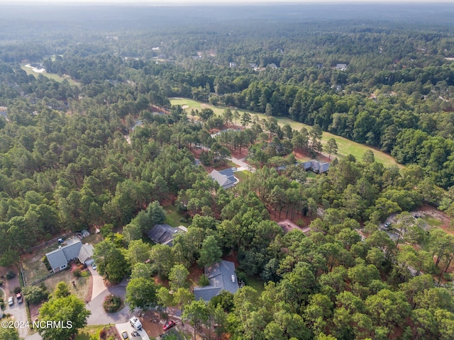 drone / aerial view featuring a wooded view