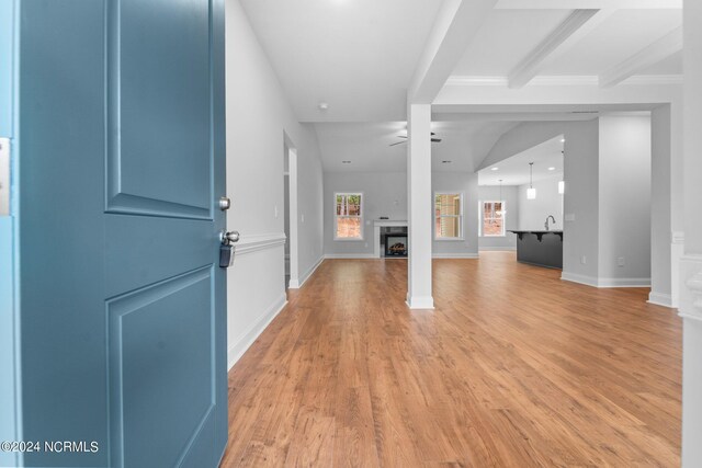 foyer entrance with beamed ceiling, light hardwood / wood-style flooring, and ceiling fan