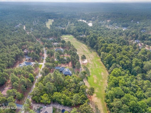 aerial view featuring a wooded view