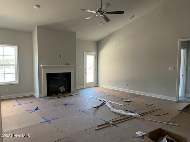 unfurnished living room featuring baseboards, a fireplace, visible vents, and a ceiling fan